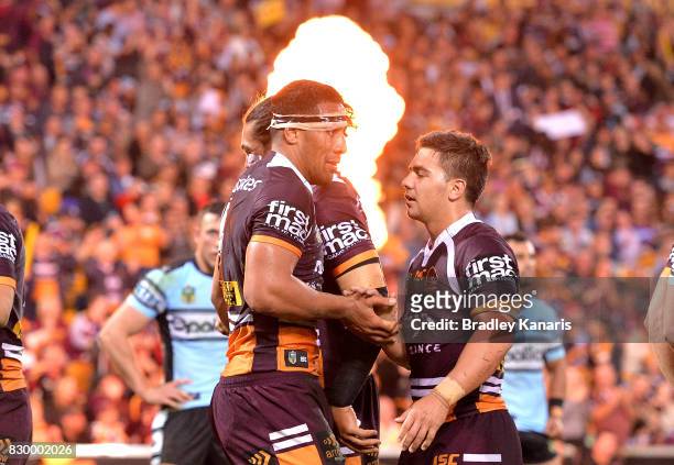 Tautau Moga of the Broncos is congratulated by team mates after scoring a try during the round 23 NRL match between the Brisbane Broncos and the...