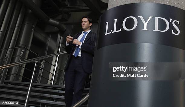 Office worker walks from the Lloyd's Building, the home of the insurance institution Lloyd's of London on September 25 2008 in London, England....