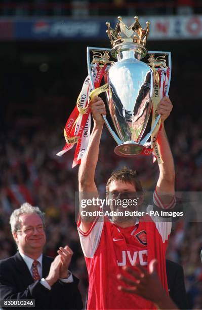 Culture Secretary Chris Smith applauds Arsenal captain Tony Adams as he holds aloft the Premier League Trophy presented to the team after their 4-0...