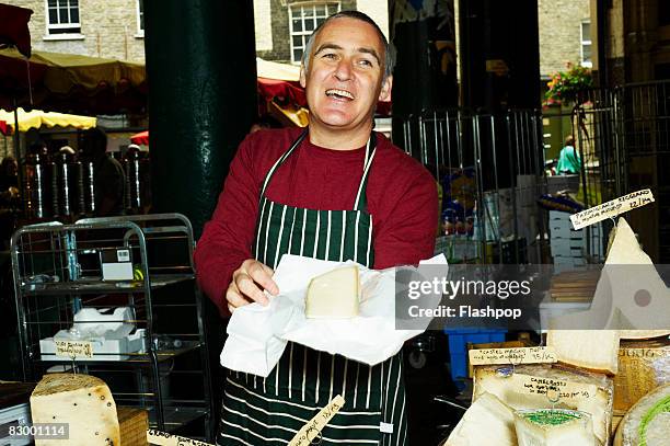 portrait of man selling fresh cheese - stand alone fotografías e imágenes de stock