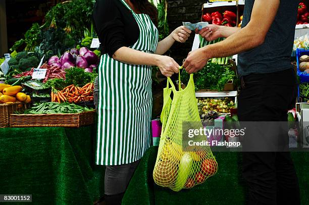 portrait of man buying fresh food at market - food market stockfoto's en -beelden