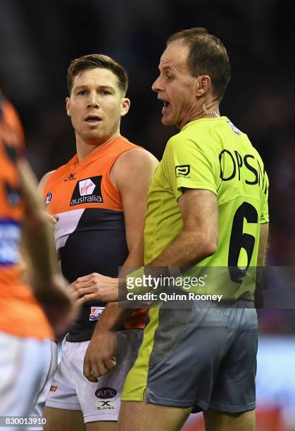 The umpire speaks with Toby Greene of the Giants after an incident with Luke Dahlhaus of the Bulldogs during the round 21 AFL match between the...