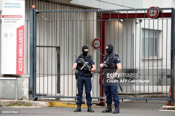 French special police officers stand guard at the entrance of the Georges Pompidou Hospital in Paris, on August 11 where the suspect in the attack of...