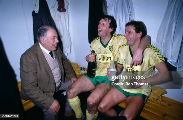 Norwich City Chairman Sir Arthur South joins Mike Channon and Asa Hartford who are celebrating in the dressing-room after Norwich had beaten Ipswich...