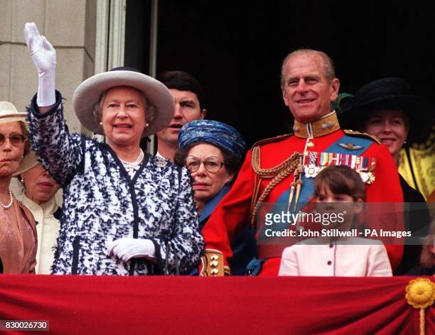 The Queen waves to the crowds as she stands on the balcony of Buckingham Palace with the Duke of Edinburgh and other members of the Royal Family...