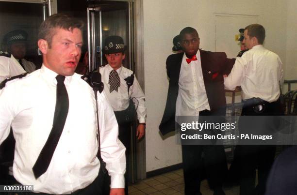 Man is taken away by police from the Stephen Lawrence Inquiry chamber after disruption in the chamber and a man tried to approach Jamie Acourt the...