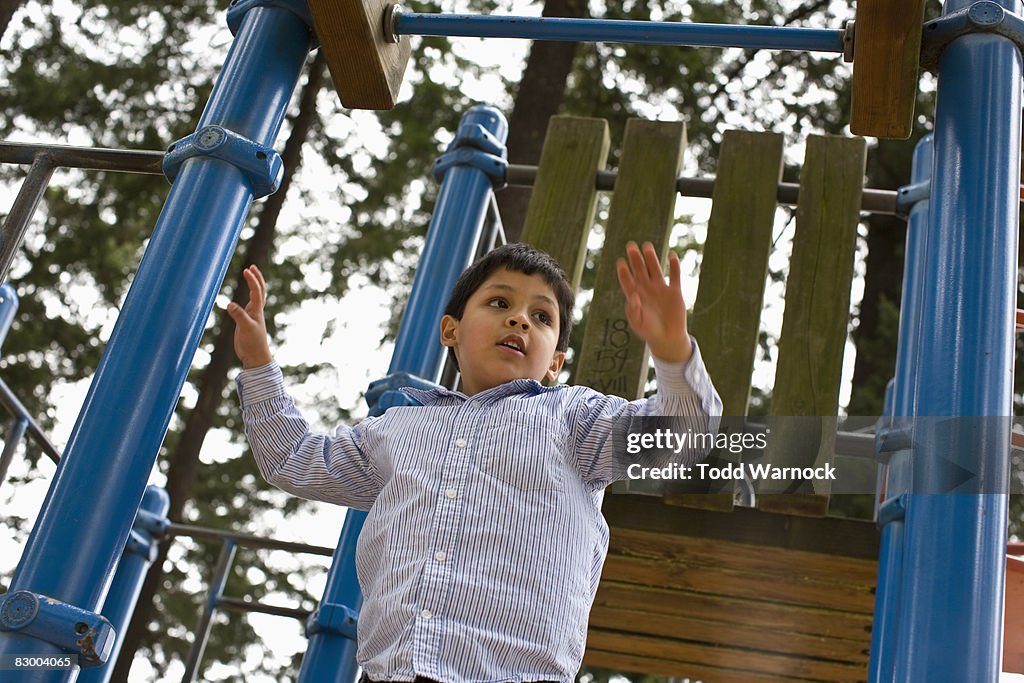 Boy on playground jungle gym 