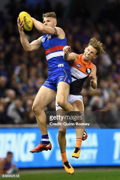 Jake Stringer of the Bulldogs marks infront of Lachie Whitfield of the Giants during the round 21 AFL match between the Western Bulldogs and the...