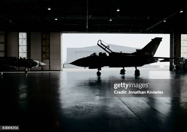 plane inside aircraft hanger  - aereo militare foto e immagini stock