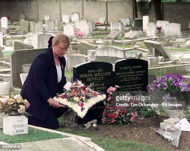 Maria Dingwall-Bentley lays a wreath bearing the words "Justice at last" at the grave of her uncle, Derek Bentley, at Croydon Cemetary, today , after...