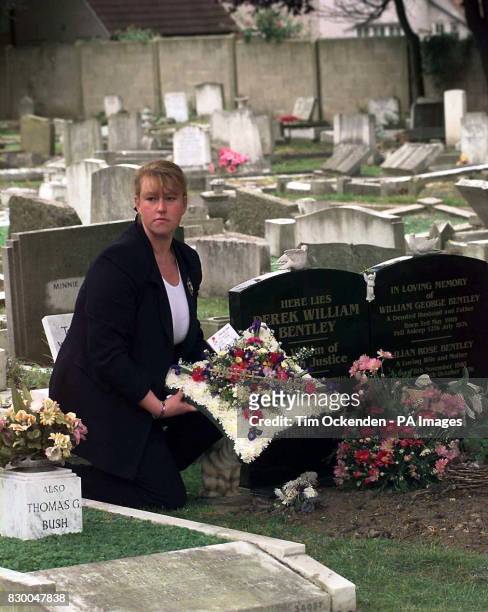 Maria Dingwall-Bentley lays a wreath bearing the words "Justice at last" at the grave of her uncle, Derek Bentley, at Croydon Cemetary, today , after...