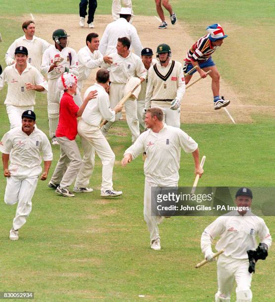 An supporter grabs a stump as England captain Alec Stewart races off with another after defeating South Africa to win England's first major Test...