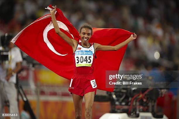 Summer Olympics: Turkey Elvan Abeylegesse victorious with flag after winning Women's 10,000M Final silver medal at National Stadium . Beijing, China...