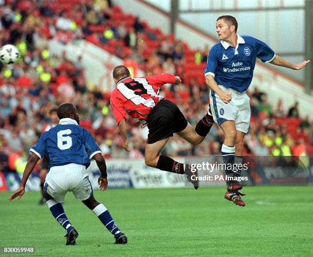 Birmingham's Gary Ablett in mid-air combat with Sheffield United' s Paul Devlin, today . Photo by Paul Barker/PA