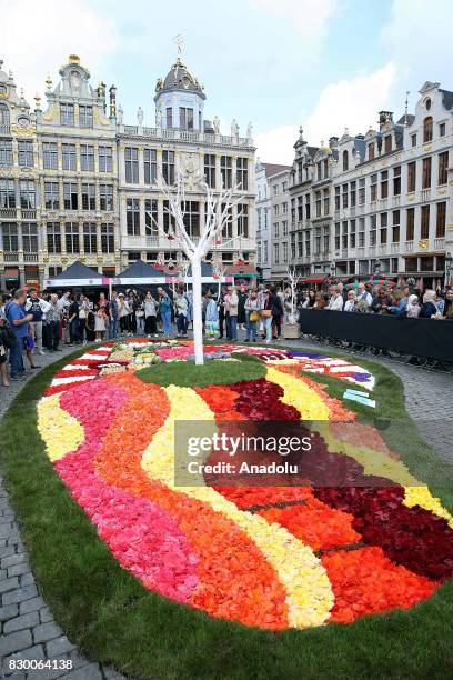 Participants and attendees form flower carpet by using flower leaves, fruits and vegetables at Grand Place during Flowertime Festival in Brussels,...