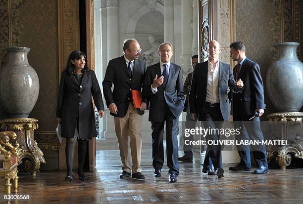 Chairman of the Management Board of Unibail-Rodemco Guillaume Poitrinal listens to Paris mayor Bertrand Delanoe walking next to Swiss architect...