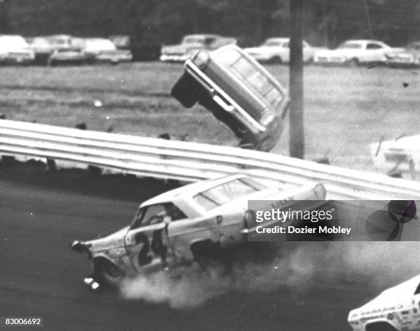 Driver Cale Yarborough goes over the wall in his Banjo Matthews 1965 Ford after being wrecked by Sam McQuagg at the Southern 500 on September 6, 1965...