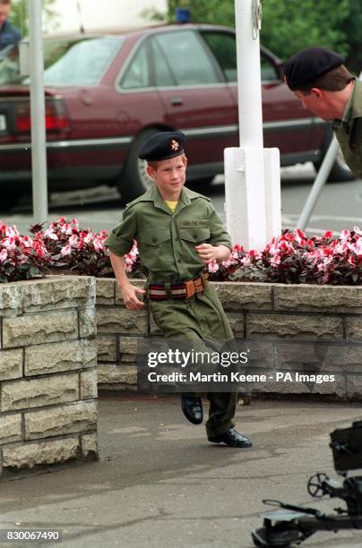 PRINCE HARRY RUNS TOWARDS A LIGHT TANK DURING A VISIT TO THE BARRACKS OF THE LIGHT DRAGOONS IN HANOVER, GERMANY.