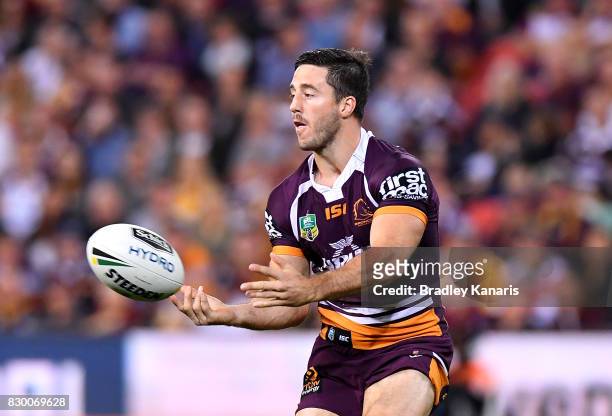 Ben Hunt of the Broncos passes the ball during the round 23 NRL match between the Brisbane Broncos and the Cronulla Sharks at Suncorp Stadium on...