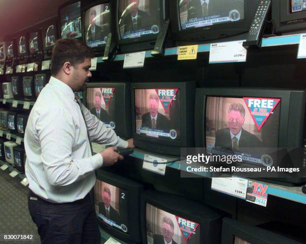 Shop assistant at the Tempo Electrical Shop, in London, tunes into US President, Bill Clinton's grand jury testimony, shown on TV worldwide today ....