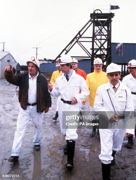 Prince Charles in overalls and a protective helmet at the Wheal Concord Tin Mine at Skinners Bottom, Blackwater, near Truro, Cornwall.