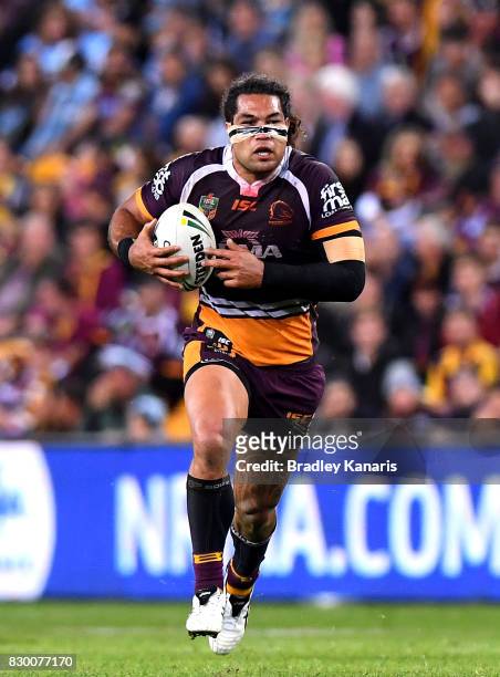 Adam Blair of the Broncos runs with the ball during the round 23 NRL match between the Brisbane Broncos and the Cronulla Sharks at Suncorp Stadium on...