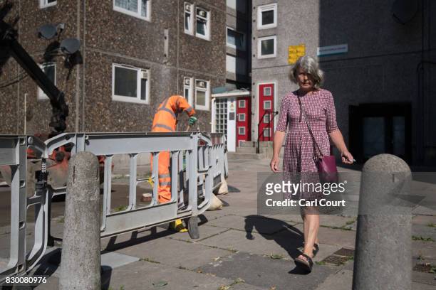 Resident leaves a tower block on the Ledbury Estate on August 11, 2017 in London, England. Hundreds of residents of the estate are to be evacuated...