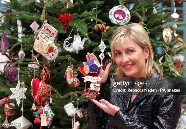 Presenter Fiona Phillips views some of the hundreds of hand stitched Christmas decorations which will adorn Her Majesty the Queen's Christmas tree at...