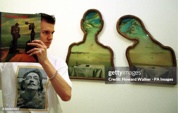 Nathan Lloyd, aged 25, from Wolverhampton taking on a almost surreal pose as he studies Salvador Dali's 'People with Clouds in their Heads' painting,...