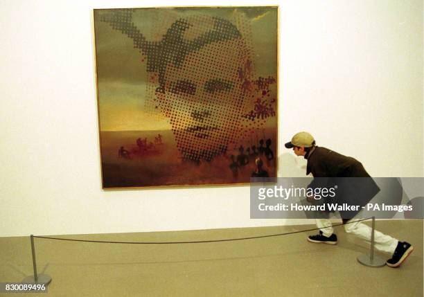 Andrew Price, aged 13, from Cambridge studies the detail in Salvador Dali's 'Portrait of my Dead Brother' one of many items on display at the...