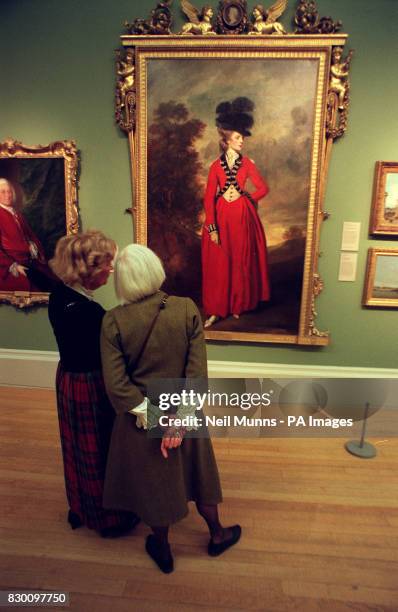 Two members of the public view a portrait of Lady Worsley at the Tate Gallery in London. The painting is part of an exhibition titled 'In...