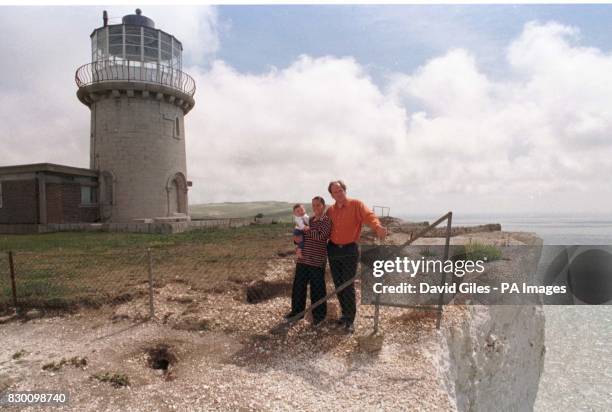 Mark and Louise Roberts with their daughter Haven outside their home, the Belle Tout lighthouse at Beachy Head, near Eastbourne, Sussex which stands...