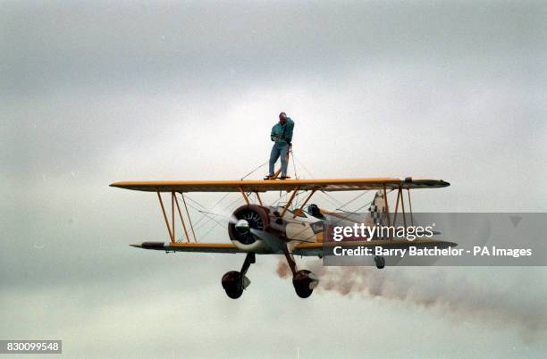 PA NEWS PHOTO 25/9/95 BERGERAC STAR JOHN NETTLES TAKES TO THE SKIES AFTER BEING STRAPPED TO A STEARMAN AIRCRAFT FOR HIS FIRST WING WALK AT EXETER...