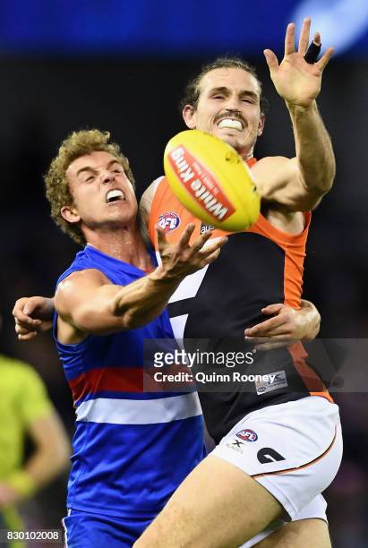 Mitch Wallis of the Bulldogs and Phil Davis of the Giants compete for a mark during the round 21 AFL match between the Western Bulldogs and the...