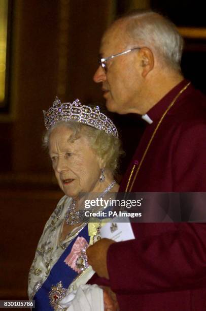 The Queen Mother walks with the Archbishop of Canterbury George Carey as they enter the Waterloo Chamber prior to the State Dinner held at Windsor...