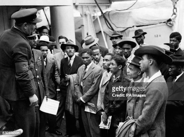 Jamaican immigrants are welcomed by RAF officials from the Colonial Office after they arrived on the ex-troopship HMT Empire Windrush at Tilbury,...