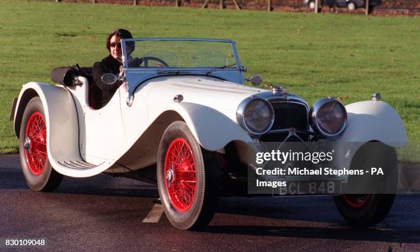 Jaguar SS100 2.5 litre two-seater sports. Helen Griffith of Sotheby's sits a 1939 Jaguar SS100 2.5 litre two-seater sports at RAF Hendon, today . The...