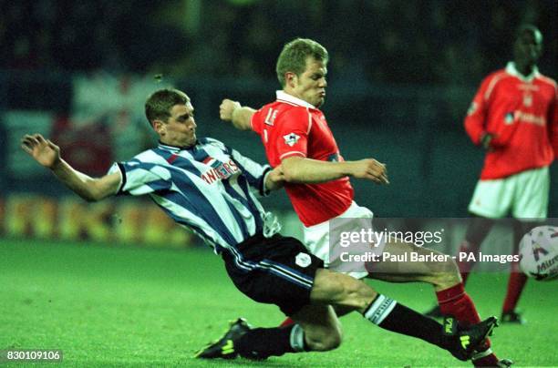 Sheffield Wednesday's Andy Booth gets tangled up with Forrest's Jon Olav hjelde at Hillsbrough tonight . Photo by Paul Barker/PA