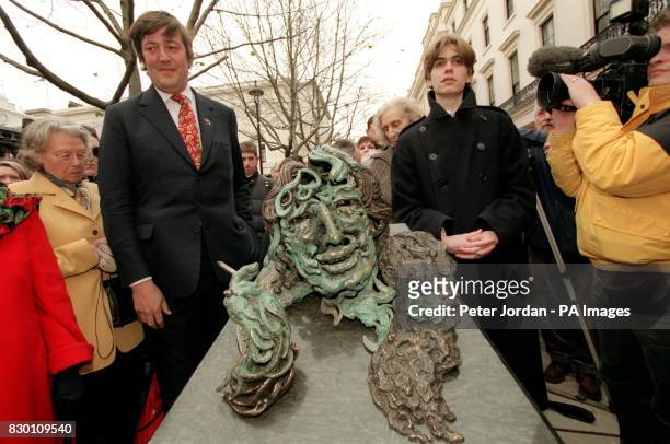 Actor Stephen Fry and Oscar Wilde's great-grandson Lucian Holland with a statue of the Irish writer by Maggi Hambling which he unveiled near London's...