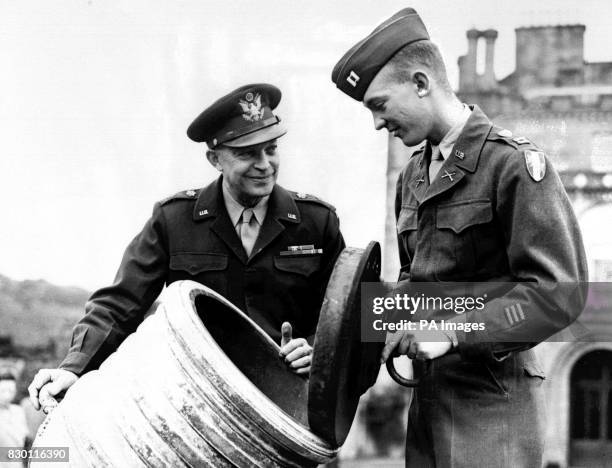 General Dwight D. Eisenhower and his son, Captain John Eisenhower, examine a Scottish "secret weapon" of several centuries ago in the grounds of the...