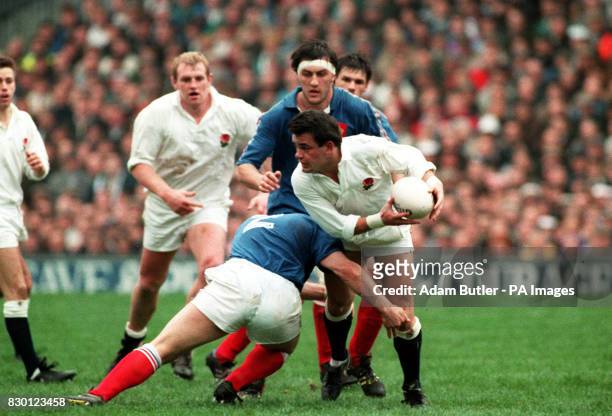 England captain Will Carling is put under pressure as team-mate Dean Richards runs in to provide support during the international rugby union match...