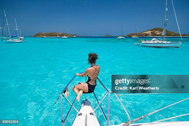 woman sitting on sailboat - tobago cays stock pictures, royalty-free photos & images