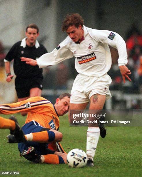 This picture may only be used within the context of an editorial feature. Swansea's Jonathan Coates is tackled by Francesco Baiano of Derby during...