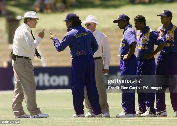 Sri Lankan Captain Arjuna Ranatunga engages in heated discussion with umpires Ross Emerson and Anthony McQuillan after bowler Muttiah Muralitharan...