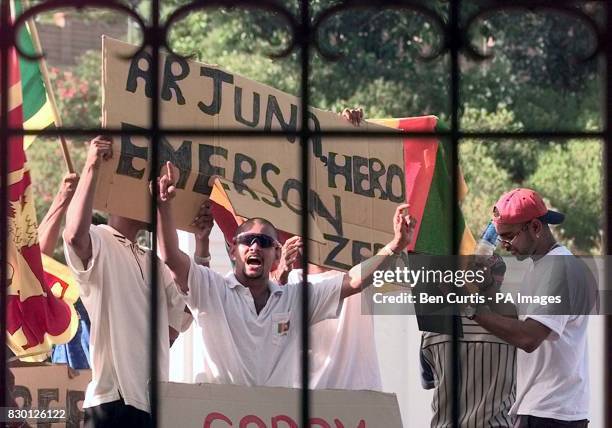 Sri Lankan protesters wait outside the gates at the WACA cricket ground in Perth where Captain Arjuna Ranatunga is facing charges arising from his...