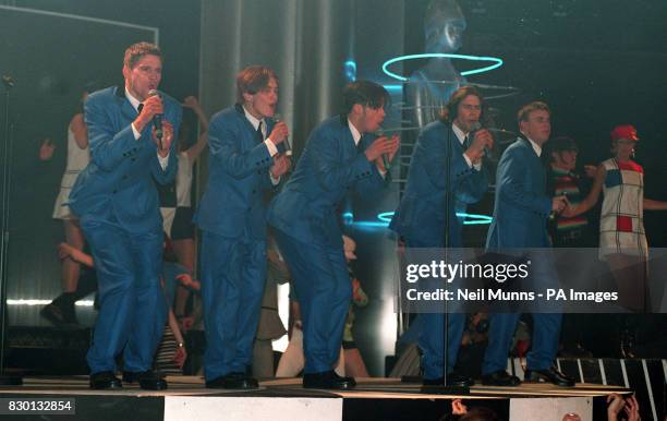 Pop group Take That perform on stage at the Brit Awards ceremony at Alexandra Palace, in London, after receiving the best single and best video...