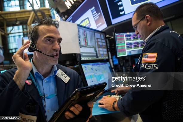 Traders and financial professionals work the floor of the New York Stock Exchange ahead of the opening bell, August 11, 2017 in New York City. After...