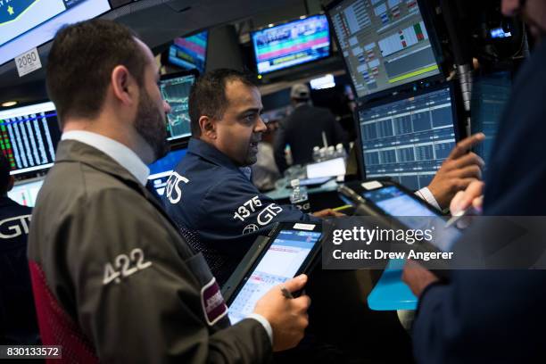 Traders and financial professionals work the floor of the New York Stock Exchange ahead of the opening bell, August 11, 2017 in New York City. After...