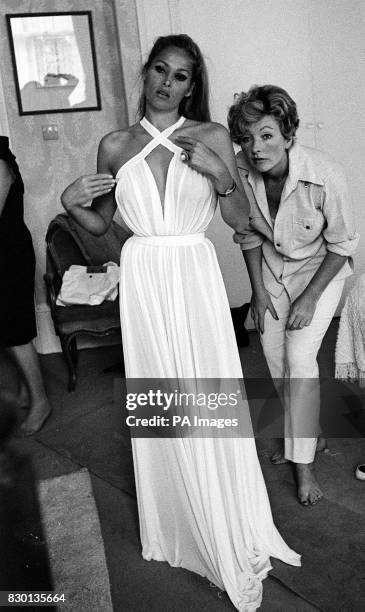Actress Ursula Andress tries on a chiffon dress, designed by Julie Harris , for a sequence in the James Bond film 'Casino Royale'.