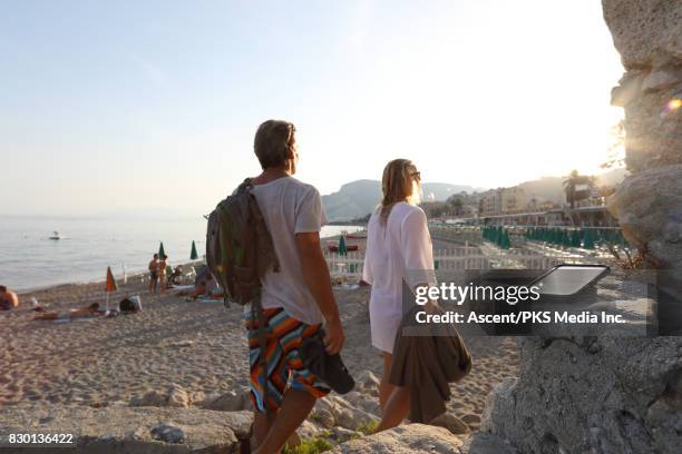 smart phone is forgotten or left behind by couple at beach - smart shoes stock pictures, royalty-free photos & images